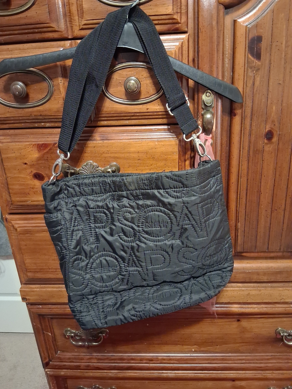 Black Quilted Shoulder Bag with The Words "Soap Net" On It